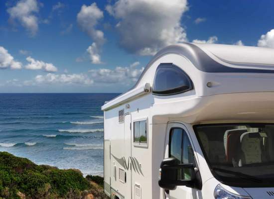 Camper parked overlooking beach and ocean